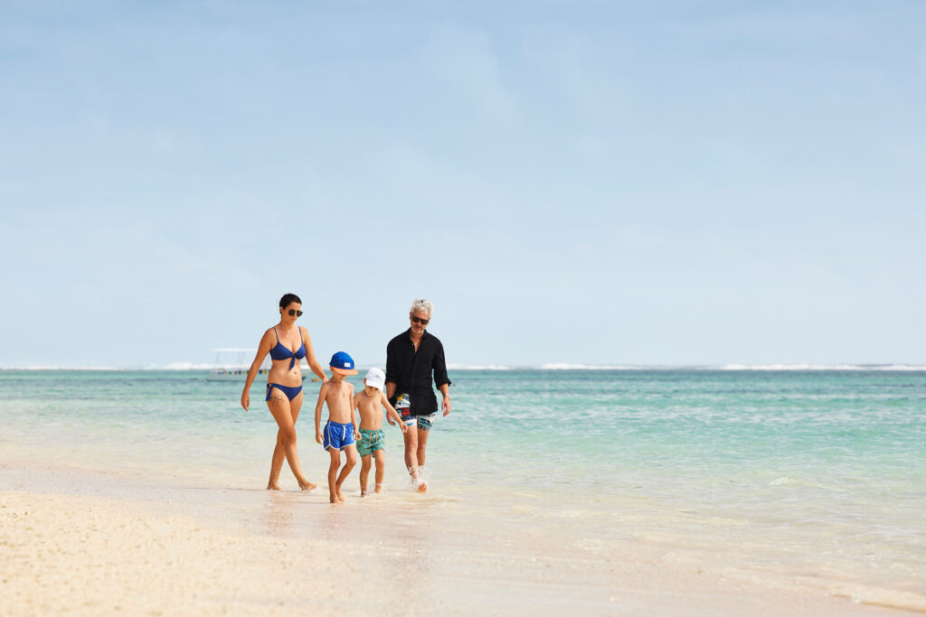 family walking along beach