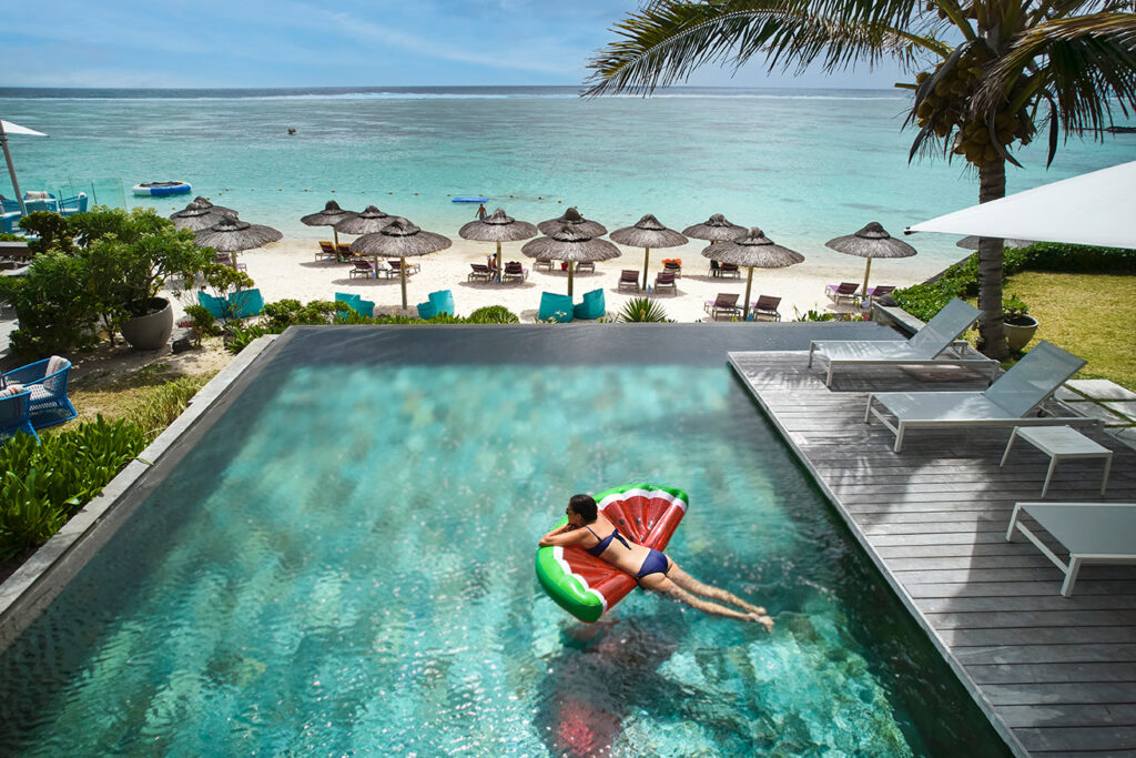lady in pool by the beach