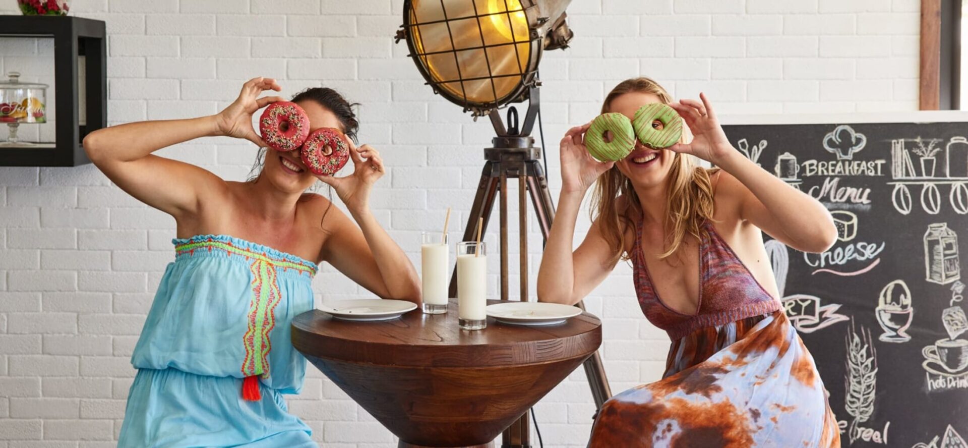 happy women with doughnuts