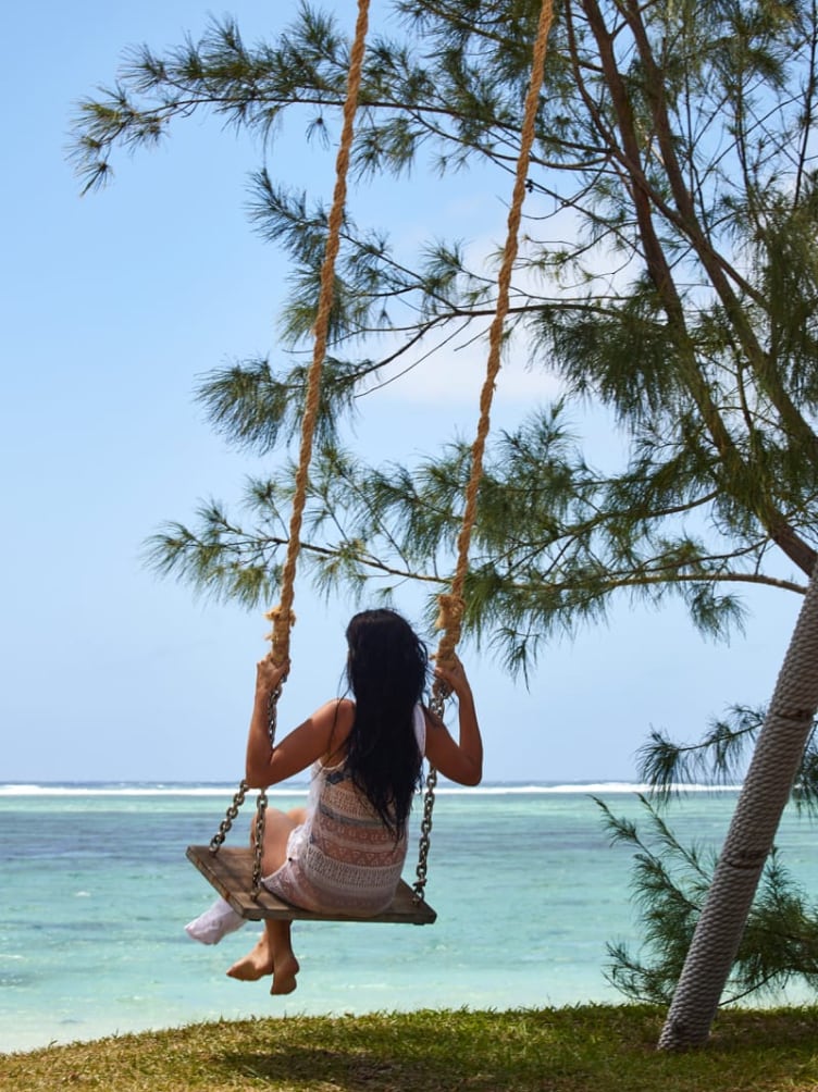 c mauritius lady by the beach on a swing